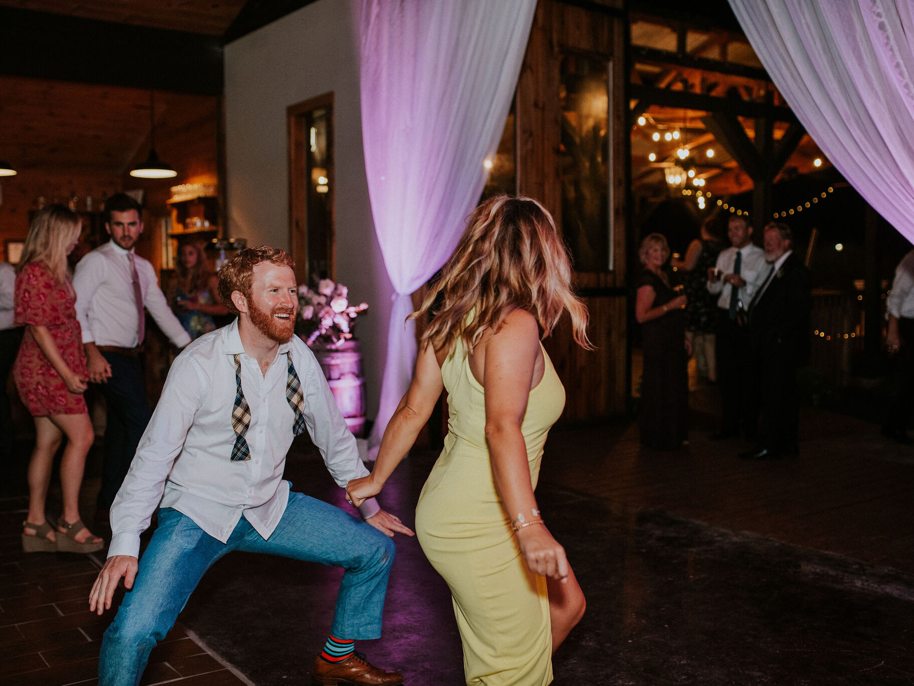 Uplighting on a barrel, flowers, and drapes at White Oaks Barn in Dahlonega, GA