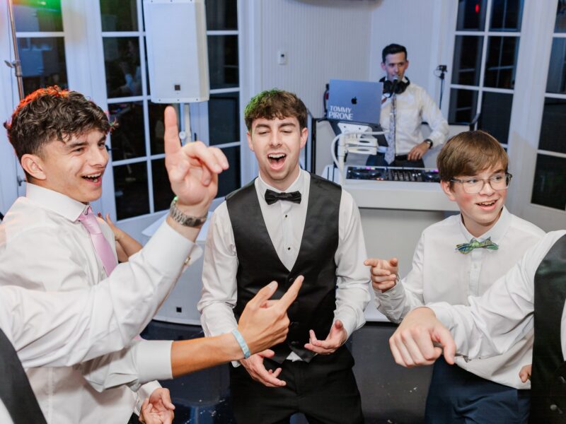 DJ Tommy Pirone at booth - groom and friends singing - Little River Farms wedding Groom and groomsmen singing in a circle while DJ Tommy Pirone plays at the DJ booth at a Little River Farms wedding in Alpharetta GA